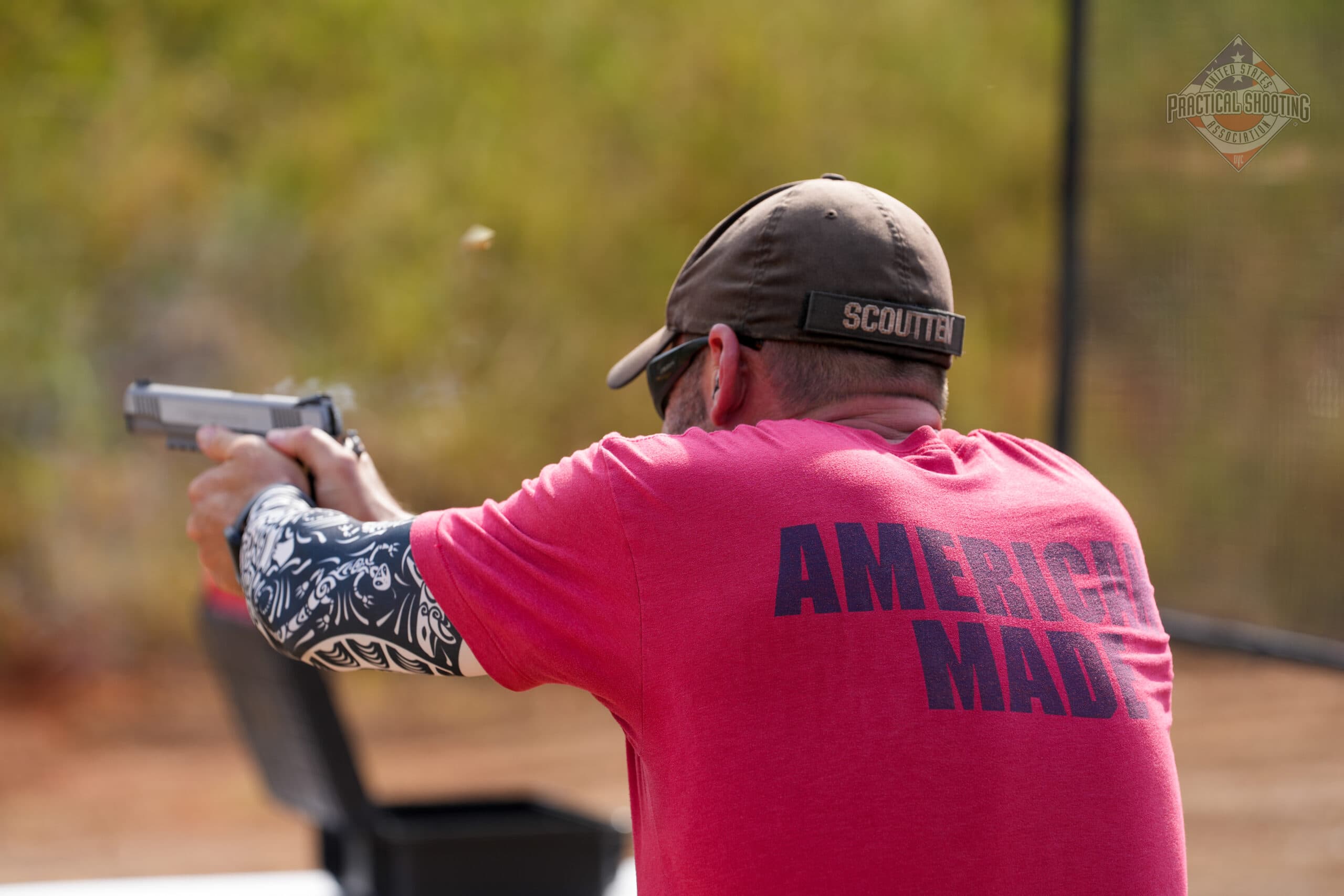 Practical shooting competitor engaging targets dynamically in a shooting sport