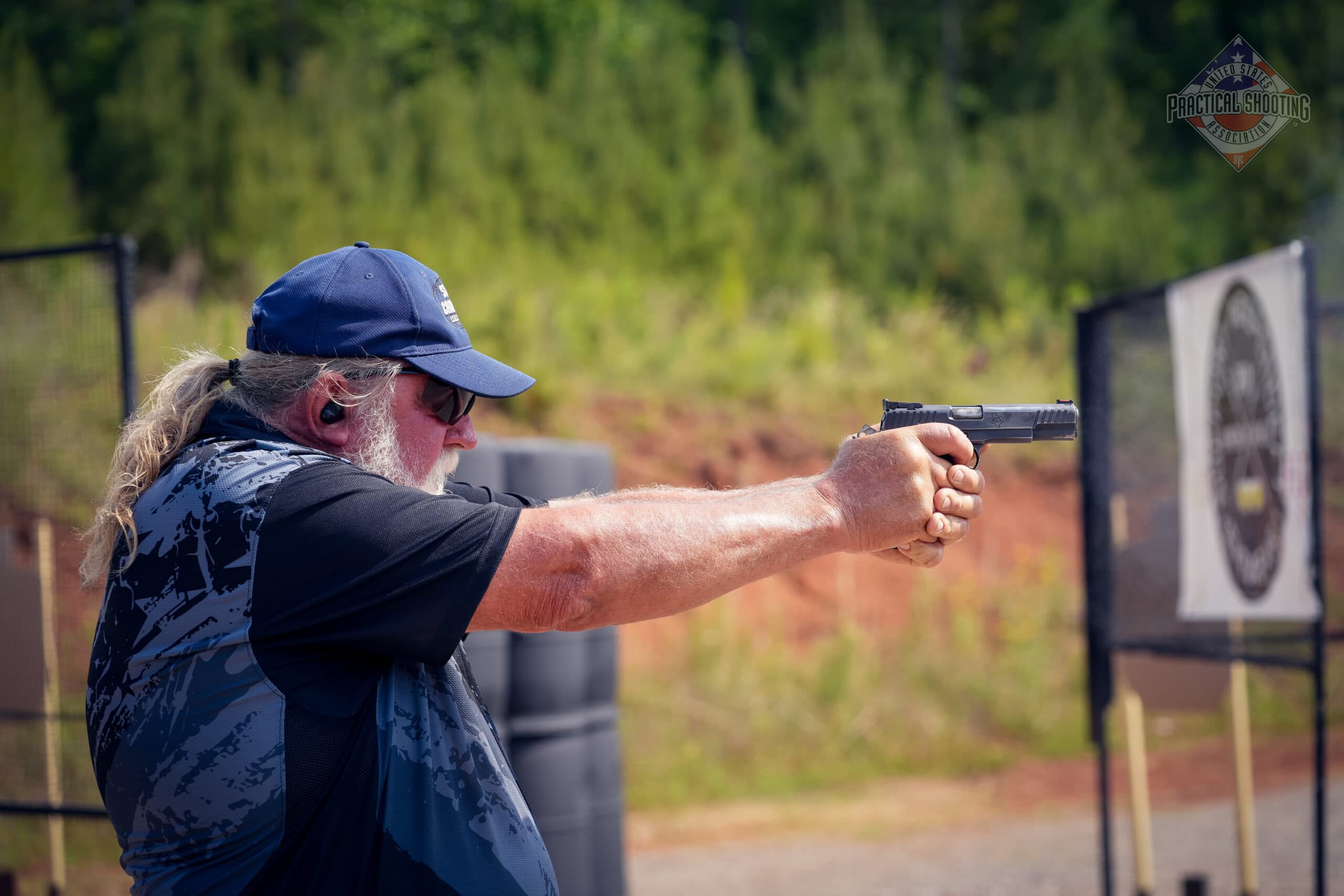 Competitive shooter practicing to improve hit factor in practical shooting