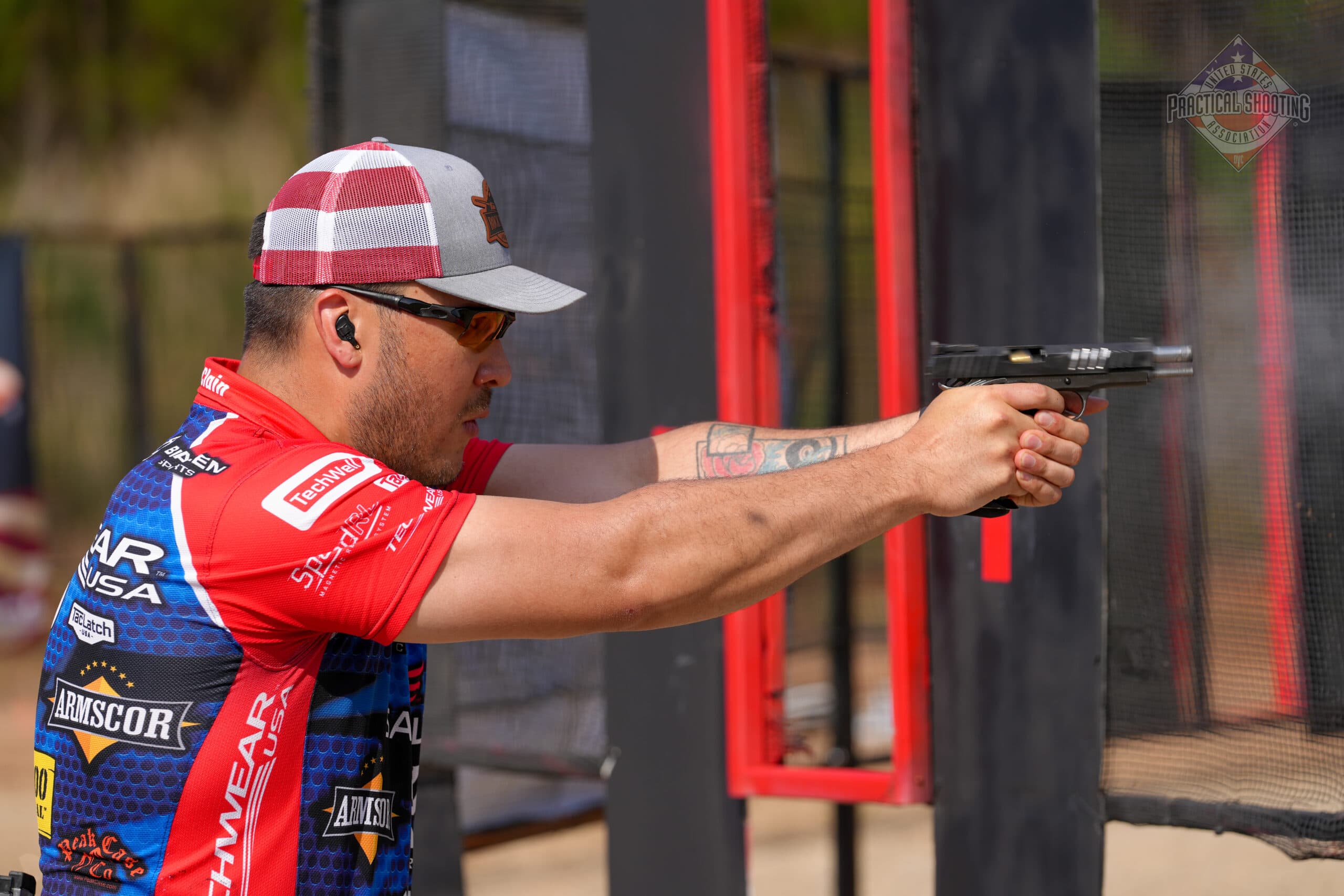 USPSA competition stage showcasing hit factor scoring in action