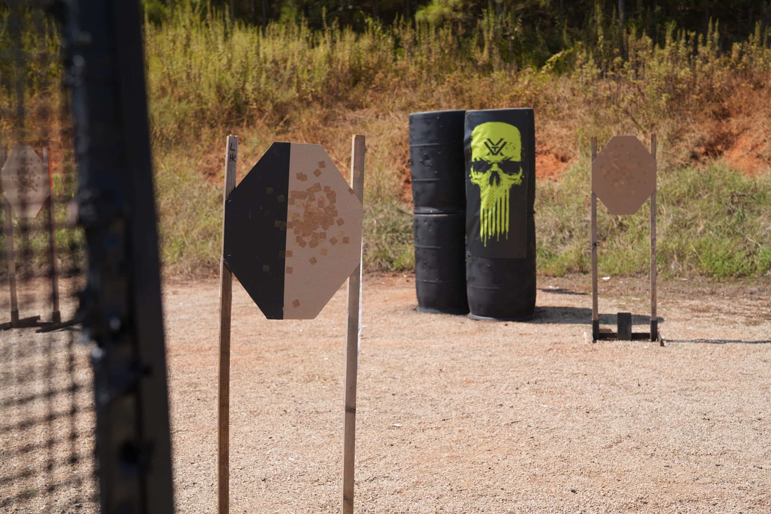 Practical shooting competitor aiming downrange at a USPSA match